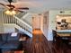 Inviting living room features wood floors, a staircase, and an open layout leading into the kitchen at 1162 Carmel Cir # 100, Casselberry, FL 32707