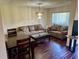 Bright living and dining room area featuring hardwood floors and plush seating at 1162 Carmel Cir # 100, Casselberry, FL 32707