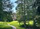 Scenic view of sidewalk leading to building with lush green landscaping and trees at 1162 Carmel Cir # 100, Casselberry, FL 32707