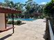 Beautiful community pool area with tiled surroundings, seating, and lush landscaping at 1162 Carmel Cir # 100, Casselberry, FL 32707