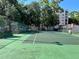 Well-maintained community tennis court surrounded by trees and fencing at 1162 Carmel Cir # 100, Casselberry, FL 32707