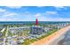 Aerial view of building with ocean access, community pool, and nearby shopping at 1239 Ocean Shore Blvd # 3C3, Ormond Beach, FL 32176