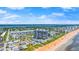 Aerial view of building with ocean access, community pool, and nearby shopping at 1239 Ocean Shore Blvd # 3C3, Ormond Beach, FL 32176