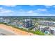 Expansive aerial view of a beachfront high-rise condominium with a pool, beach access and parking at 1239 Ocean Shore Blvd # 3C3, Ormond Beach, FL 32176