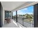 Balcony view with a seating area overlooking palm trees, parking area, and a glimpse of the ocean at 1239 Ocean Shore Blvd # 3C3, Ormond Beach, FL 32176