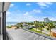 View from the balcony of the neighborhood with palm trees, the ocean, and a glimpse of the beach at 1239 Ocean Shore Blvd # 3C3, Ormond Beach, FL 32176