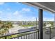 A scenic view from the balcony overlooking the palm trees, city street, and commercial area at 1239 Ocean Shore Blvd # 3C3, Ormond Beach, FL 32176