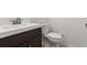 Powder room featuring modern sink with dark wood cabinet and commode at 1239 Ocean Shore Blvd # 3C3, Ormond Beach, FL 32176