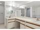 Well lit bathroom featuring an extended vanity with double sinks and large mirror at 1239 Ocean Shore Blvd # 3C3, Ormond Beach, FL 32176