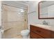 Bathroom with a tiled shower, glass door, wood vanity and granite countertop at 1239 Ocean Shore Blvd # 3C3, Ormond Beach, FL 32176