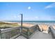 Outdoor shower next to beach access featuring stairs and ocean views at 1239 Ocean Shore Blvd # 3C3, Ormond Beach, FL 32176