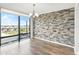 Bright dining area with stone accent wall and outdoor views at 1239 Ocean Shore Blvd # 3C3, Ormond Beach, FL 32176