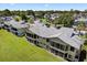Aerial view of a multi-Gathering residence surrounded by lush green lawns and community amenities at 133 Blue Heron Dr # D, Daytona Beach, FL 32119