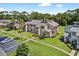 Aerial view of a well-maintained townhome community with ample parking and green spaces at 133 Blue Heron Dr # D, Daytona Beach, FL 32119