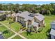 Beautifully landscaped townhome aerial view with lush greenery and mature trees at 133 Blue Heron Dr # D, Daytona Beach, FL 32119