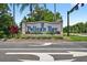Pelican Bay community entrance sign with manicured landscaping and clear directional signage at 133 Blue Heron Dr # D, Daytona Beach, FL 32119