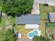 Aerial view of the home's roof, covered patio, pool, sheds, and backyard at 1505 Valencia Ave, Daytona Beach, FL 32117