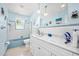 Bathroom with a tub and shower combo, updated vanity with a granite countertop and modern lighting at 1505 Valencia Ave, Daytona Beach, FL 32117
