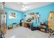 Brightly lit room with two windows, ceiling fan, desk, and surfboard against the wall at 1505 Valencia Ave, Daytona Beach, FL 32117