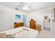 Spacious bedroom with white walls, ceiling fan, and access to en-suite bathroom at 1505 Valencia Ave, Daytona Beach, FL 32117