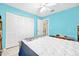 Bright bedroom with a large closet, aqua walls, ceiling fan, and white-painted trim at 1505 Valencia Ave, Daytona Beach, FL 32117