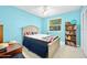 Comfortable bedroom featuring a queen-size bed with blue accent, large window, ceiling fan, and closet at 1505 Valencia Ave, Daytona Beach, FL 32117