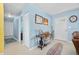 Light and airy foyer with a surfboard accent rug, light blue walls, coat closet, and stylish entryway table at 1505 Valencia Ave, Daytona Beach, FL 32117