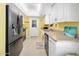 Galley kitchen featuring stainless steel appliances, neutral countertops, and white cabinetry at 1505 Valencia Ave, Daytona Beach, FL 32117