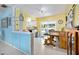 Eat-in kitchen featuring white cabinetry and ample natural light from the sliding glass doors at 1505 Valencia Ave, Daytona Beach, FL 32117