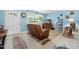 Cozy living room with blue walls, a comfortable recliner, a decorative rug, and stylish decor at 1505 Valencia Ave, Daytona Beach, FL 32117