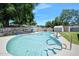 Backyard swimming pool, surrounded by mature trees and fenced perimeter at 1505 Valencia Ave, Daytona Beach, FL 32117