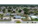 This aerial image features neighborhood homes, green landscape, a swimming pool, and a community center at 209 Falcon Ave, Edgewater, FL 32141