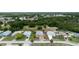 Aerial view of a neighborhood with several homes featuring well-maintained lawns and trees, including the house at 209 Falcon Ave, Edgewater, FL 32141