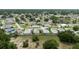 An aerial view showing a residential neighborhood with various homes, mature trees, and well-kept lawns at 209 Falcon Ave, Edgewater, FL 32141