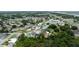 Wide angle aerial view of a neighborhood with an arrow pointing to a house and trees in the background at 209 Falcon Ave, Edgewater, FL 32141
