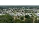 The aerial shot displays a peaceful residential area with verdant trees, quaint houses, and manicured lawns at 209 Falcon Ave, Edgewater, FL 32141