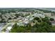 Aerial view captures a neighborhood with tidy homes, lush trees, and easy access to nearby amenities at 209 Falcon Ave, Edgewater, FL 32141