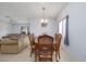 Inviting dining room featuring neutral walls, tile flooring and a modern light fixture at 209 Falcon Ave, Edgewater, FL 32141