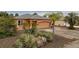 Exterior view of a home featuring a well-manicured lawn and desert-themed landscaping elements at 209 Falcon Ave, Edgewater, FL 32141