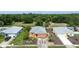 Exterior aerial view of a house with gray roof and orange exterior with small trees in a residential area at 209 Falcon Ave, Edgewater, FL 32141