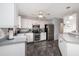 Bright kitchen with tile floors, stainless steel appliances and white cabinetry at 209 Falcon Ave, Edgewater, FL 32141