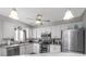 Bright kitchen featuring white cabinets, stainless steel appliances, and modern lighting fixtures at 209 Falcon Ave, Edgewater, FL 32141