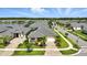 Aerial view of a neighborhood with a lake in the background at 3048 Borassus Dr, New Smyrna Beach, FL 32168