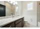 Granite counters and tiled shower featured in this bright bathroom at 3048 Borassus Dr, New Smyrna Beach, FL 32168