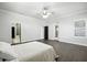 Spacious bedroom featuring hardwood floors, ceiling fan and access to ensuite bathroom and patio at 3048 Borassus Dr, New Smyrna Beach, FL 32168