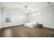 Bright bedroom with hardwood flooring, ceiling fan, and large windows allowing for natural light at 3048 Borassus Dr, New Smyrna Beach, FL 32168
