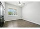 This bright bedroom features hardwood flooring, a window with shutters and a ceiling fan at 3048 Borassus Dr, New Smyrna Beach, FL 32168