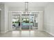 Open dining room with tiled floor and views of the pool at 3048 Borassus Dr, New Smyrna Beach, FL 32168