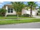 Well-maintained home featuring lush green lawn, landscape, and mature trees enhancing its curb appeal at 3048 Borassus Dr, New Smyrna Beach, FL 32168