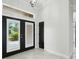 Spacious foyer with elegant double doors, bright lighting, and a neutral color palette creating a welcoming entrance at 3048 Borassus Dr, New Smyrna Beach, FL 32168